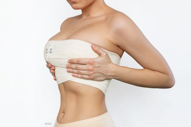 Woman with large breasts, wearing bandages around her chest